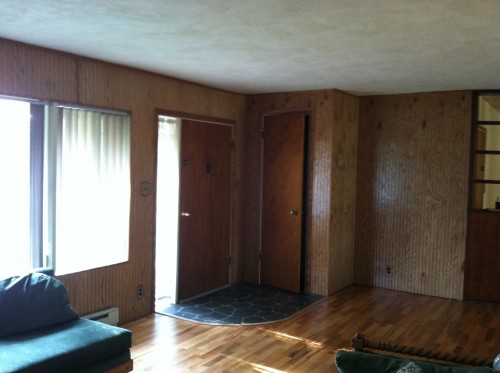 Ugly wood paneling in the living room and entry way
