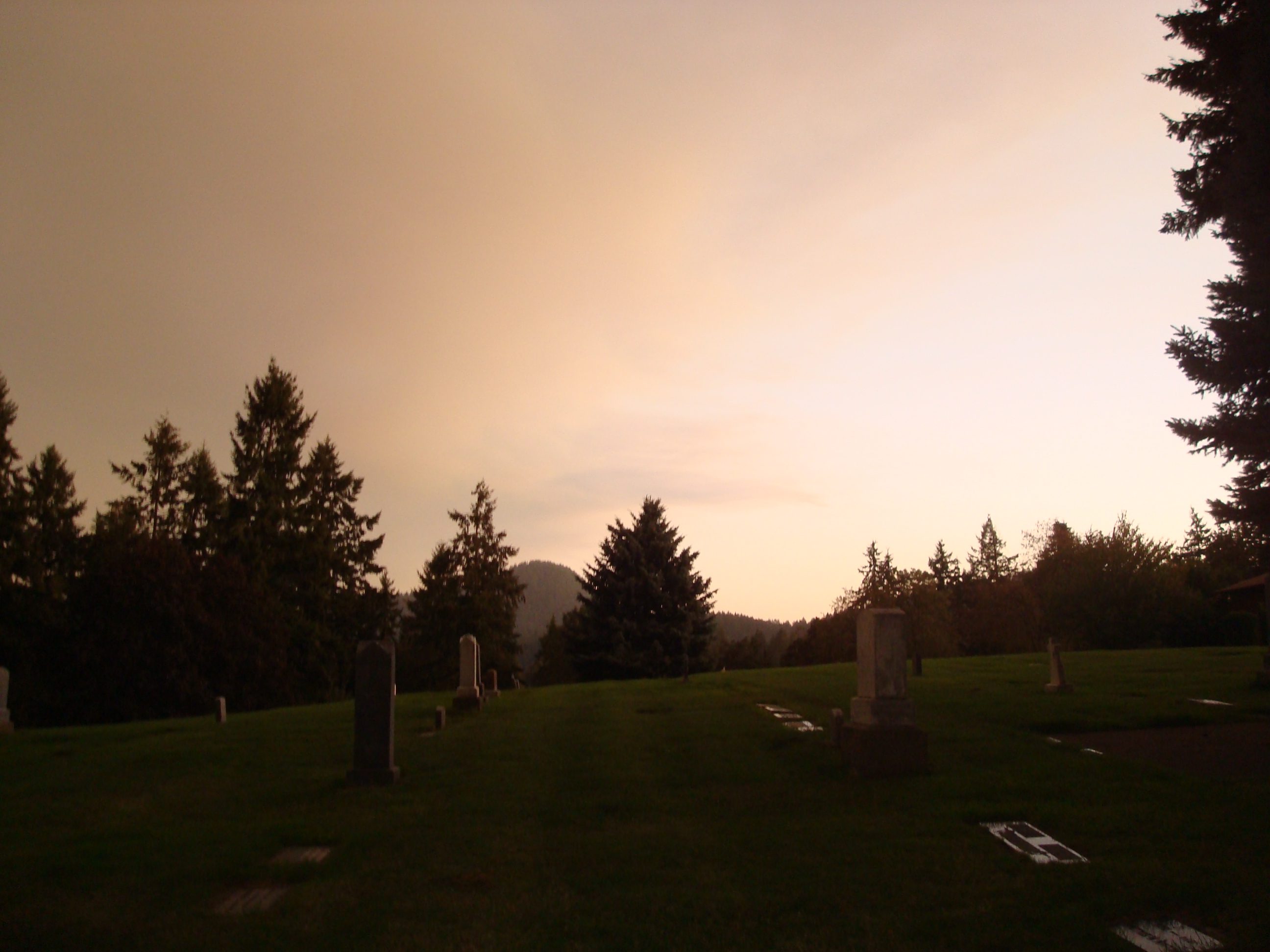 autumnal sunset over a cemetary